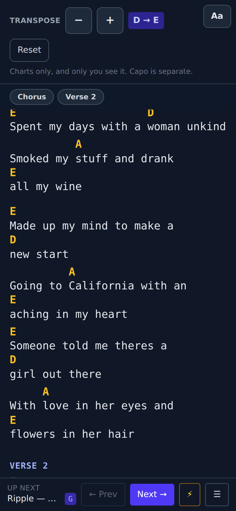 The live view on a phone: a chart reflowing to the narrow screen, each chord still directly above its own syllable, with a transpose control at the top and an "Up next" bar showing the following song alongside Prev and Next controls.